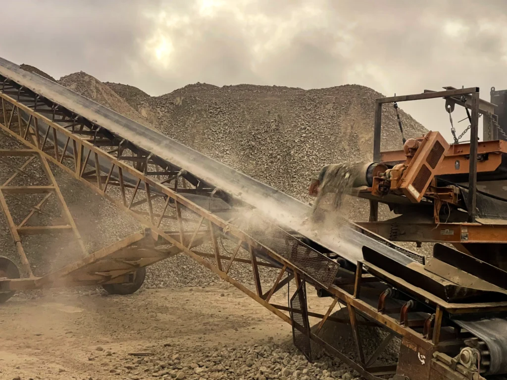 Conveyor belt moving crushed aggregate at a processing site
