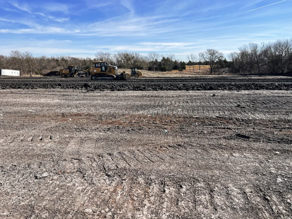 Heavy equipment grading a large commercial lot